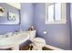 Charming powder room features a pedestal sink and soft blue walls at 7440 W 94Th Pl, Westminster, CO 80021