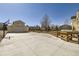 Long, spacious driveway leading to a detached garage, with a basketball hoop adding to the outdoor amenities at 7440 W 94Th Pl, Westminster, CO 80021