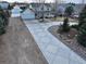 Long concrete driveway approaching an elegant home, surrounded by mature trees at 7440 W 94Th Pl, Westminster, CO 80021