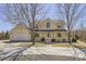 Inviting yellow two-story home boasting a charming wrap-around porch, large windows, and a two car garage at 7440 W 94Th Pl, Westminster, CO 80021