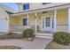 Charming covered front porch with swing and seating area, complemented by attractive landscaping and lighting at 7440 W 94Th Pl, Westminster, CO 80021