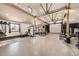 Spacious home gym with exposed beams, gym equipment, and natural light, perfect for a workout at 7440 W 94Th Pl, Westminster, CO 80021