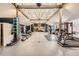 Large home gym featuring modern exercise equipment, high ceilings, and a basketball hoop for fitness enthusiasts at 7440 W 94Th Pl, Westminster, CO 80021