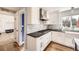 Stylish kitchen featuring stainless steel range hood, white cabinets, and hardwood floors at 7440 W 94Th Pl, Westminster, CO 80021