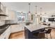 Bright kitchen featuring an island with marble countertop, white cabinets and stainless steel appliances at 7440 W 94Th Pl, Westminster, CO 80021