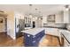 Modern kitchen featuring a large island, stainless steel appliances, white cabinets, and hardwood floors at 7440 W 94Th Pl, Westminster, CO 80021