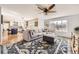 Spacious living room with large windows and a blue patterned rug that complement the light gray sectional sofa at 7440 W 94Th Pl, Westminster, CO 80021