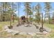 Enjoy the outdoors with a playhouse and fire pit area in this landscaped backyard, great for Gathering fun at 29266 S Sunset Trl, Conifer, CO 80433