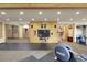 Spacious finished basement for fitness and entertainment with hardwood details, a large tv, and ample storage space at 29266 S Sunset Trl, Conifer, CO 80433