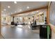 Bright home gym featuring multiple workout machines, mirrors, and windows for a complete fitness experience at 29266 S Sunset Trl, Conifer, CO 80433