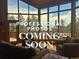 Bright living room featuring floor to ceiling windows with scenic outdoor views and comfortable seating at 29266 S Sunset Trl, Conifer, CO 80433