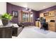 Well-lit home office featuring a bay window, wood desk, and a comfortable seating area at 29266 S Sunset Trl, Conifer, CO 80433
