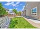 Green backyard with a lush lawn, wood fencing and an exterior view of the side of the house at 2938 S Zeno Way, Aurora, CO 80013