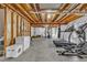 Unfinished basement with exercise equipment, providing opportunity for customization and fitness at 2938 S Zeno Way, Aurora, CO 80013