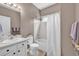Bathroom featuring vanity, toilet, and shower-tub combination with a clean white shower curtain at 2938 S Zeno Way, Aurora, CO 80013