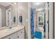 Bathroom featuring a sink and vanity, with a view leading to the bedroom through the doorway at 2938 S Zeno Way, Aurora, CO 80013