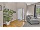 Elegant foyer with hardwood floors, a soaring ceiling, and a cozy seating area at 2938 S Zeno Way, Aurora, CO 80013