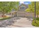 Two-story home with lush front yard, mature shade trees, and a spacious driveway leading to the garage at 2938 S Zeno Way, Aurora, CO 80013