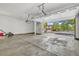 Spacious two-car garage with an open door displaying the view of the neighborhood street at 2938 S Zeno Way, Aurora, CO 80013