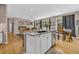 Open kitchen featuring a granite island, modern appliances, and wood floors, seamlessly connecting to the adjacent living and dining area at 2938 S Zeno Way, Aurora, CO 80013