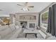 Cozy living room featuring a fireplace, large windows, and neutral decor at 2938 S Zeno Way, Aurora, CO 80013