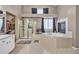 Bathroom featuring a glass-enclosed shower, soaking tub with fireplace, and walk-in closet at 2938 S Zeno Way, Aurora, CO 80013