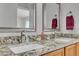 Bathroom with double vanity featuring granite countertops, undermount sinks, and modern brushed nickel faucets at 9758 Laredo St # 35B, Commerce City, CO 80022