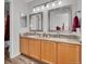 Bathroom features a double sink vanity with granite countertops, complemented by stylish silver framed mirrors at 9758 Laredo St # 35B, Commerce City, CO 80022