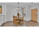 Cozy dining area featuring a chandelier, dining table and view into the living room at 9758 Laredo St # 35B, Commerce City, CO 80022