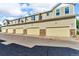 Exterior view of townhomes with garages, and neutral tan color at 9758 Laredo St # 35B, Commerce City, CO 80022