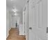 Spacious hallway with wood-look floors, neutral walls, and recessed lighting creates a welcoming transition space at 9758 Laredo St # 35B, Commerce City, CO 80022