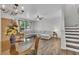 Open living room with plush seating, elegant lighting, and seamless flow to the dining area at 9758 Laredo St # 35B, Commerce City, CO 80022