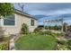 Beautiful backyard featuring a putting green and pergola-covered patio, perfect for outdoor relaxation and entertainment at 4495 Windmill Dr, Brighton, CO 80601