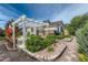 Backyard patio featuring a pergola and landscaped garden with red roses at 4495 Windmill Dr, Brighton, CO 80601