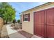 Backyard shed with red doors, complemented by a walkway and landscaping, provides storage and enhances outdoor space at 4495 Windmill Dr, Brighton, CO 80601