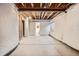 Finished basement with concrete floor, painted walls, and doorway leading to a half bathroom at 4495 Windmill Dr, Brighton, CO 80601