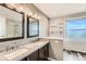 Bathroom featuring double sinks, granite counters, and decorative mirrors at 4495 Windmill Dr, Brighton, CO 80601