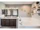 Charming bathroom features a double vanity, a soaking tub, and decorative shelving at 4495 Windmill Dr, Brighton, CO 80601