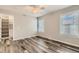 Bedroom with hardwood floors, a ceiling fan, built-in closet and windows that provide ample natural light at 4495 Windmill Dr, Brighton, CO 80601