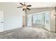 Bright bedroom featuring a ceiling fan, carpeted floors, and a bay window at 4495 Windmill Dr, Brighton, CO 80601