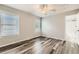 Comfortable bedroom featuring hardwood floors, neutral paint, a ceiling fan, and bright natural light at 4495 Windmill Dr, Brighton, CO 80601