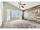 Vaulted ceiling bedroom with a decorative wood accent wall, a ceiling fan, and a bay window at 4495 Windmill Dr, Brighton, CO 80601