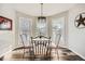 Cozy breakfast nook with dark wood floors and views from the three surrounding windows at 4495 Windmill Dr, Brighton, CO 80601