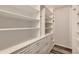 Bright walk-in closet with custom built-in shelving and drawers, perfect for organization at 4495 Windmill Dr, Brighton, CO 80601