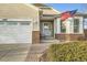 Inviting front entrance with brick accents, a well-lit porch, and manicured landscaping at 4495 Windmill Dr, Brighton, CO 80601