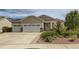 Attractive single-Gathering home with beige siding, a two-car garage, and a well-maintained lawn at 4495 Windmill Dr, Brighton, CO 80601