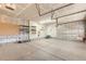 Spacious two-car garage with epoxy flooring, equipped with shelving, a peg board, and storage solutions at 4495 Windmill Dr, Brighton, CO 80601