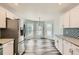 Modern kitchen with stainless steel appliances, white cabinets, and a bay window nook at 4495 Windmill Dr, Brighton, CO 80601