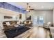 Bright living room with hardwood floors, vaulted ceiling, and a large leather sofas at 4495 Windmill Dr, Brighton, CO 80601