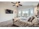 This main bedroom provides ample natural light from the bay window and has a decorative ceiling fan at 4495 Windmill Dr, Brighton, CO 80601